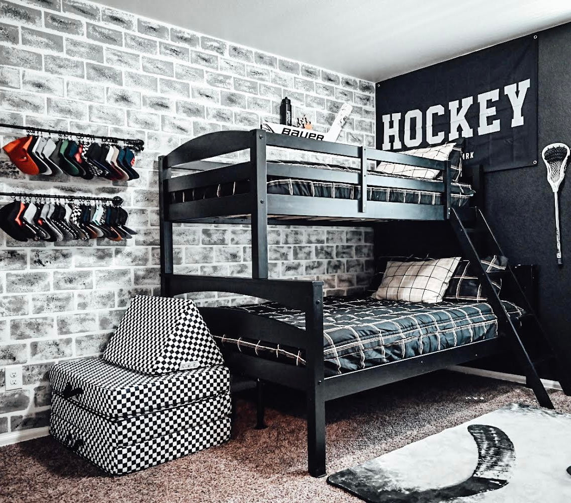 Children's bedroom with bunk bed, hockey-themed decor, and sports equipment.
