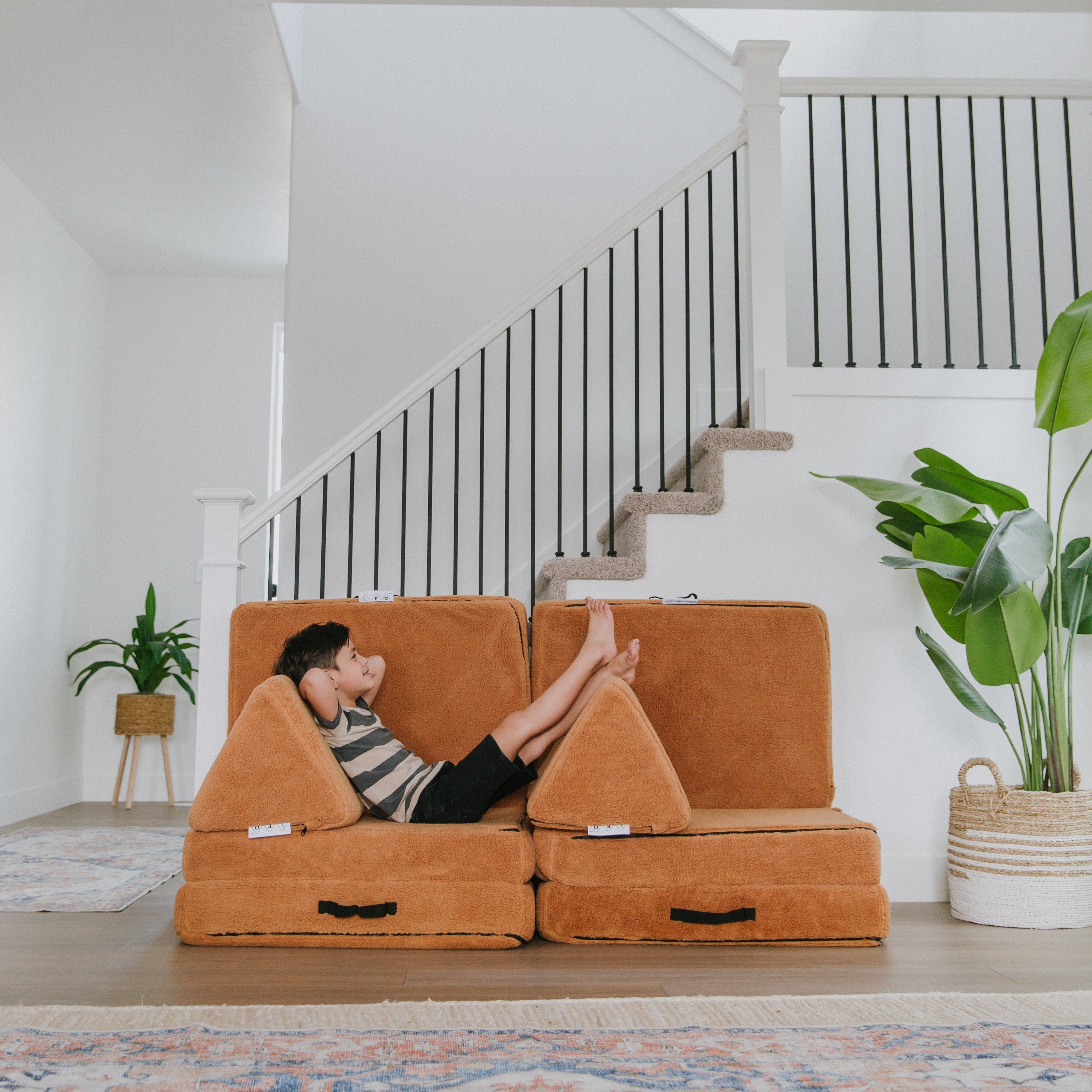 A boy laying on Leo Mat Play Couch