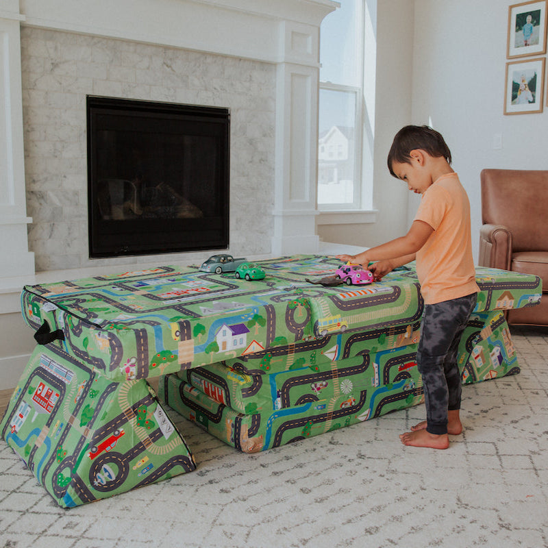 Child playing with his Leo Mat Play Couch with a roads and cars pattern
